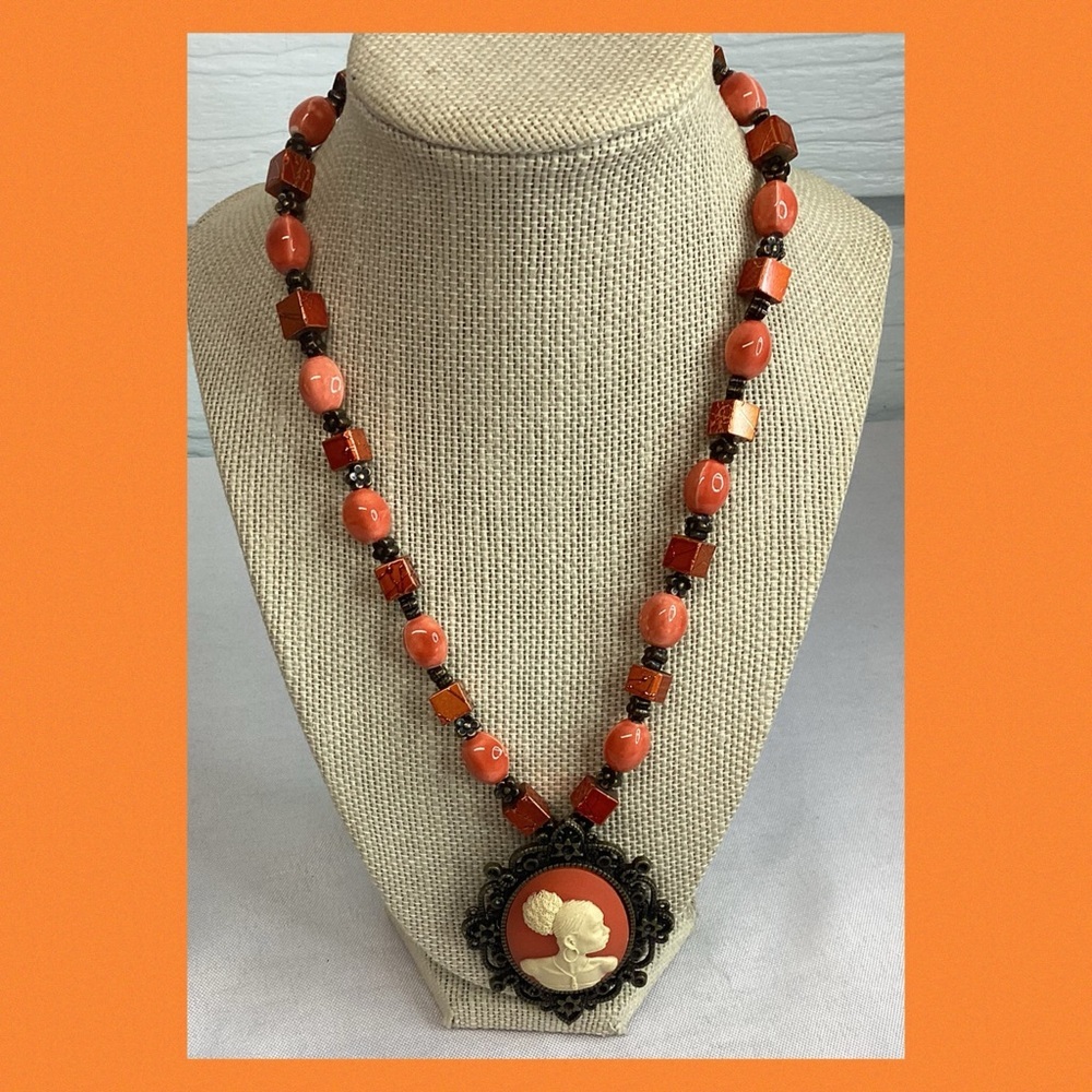 Orange cameo necklace.